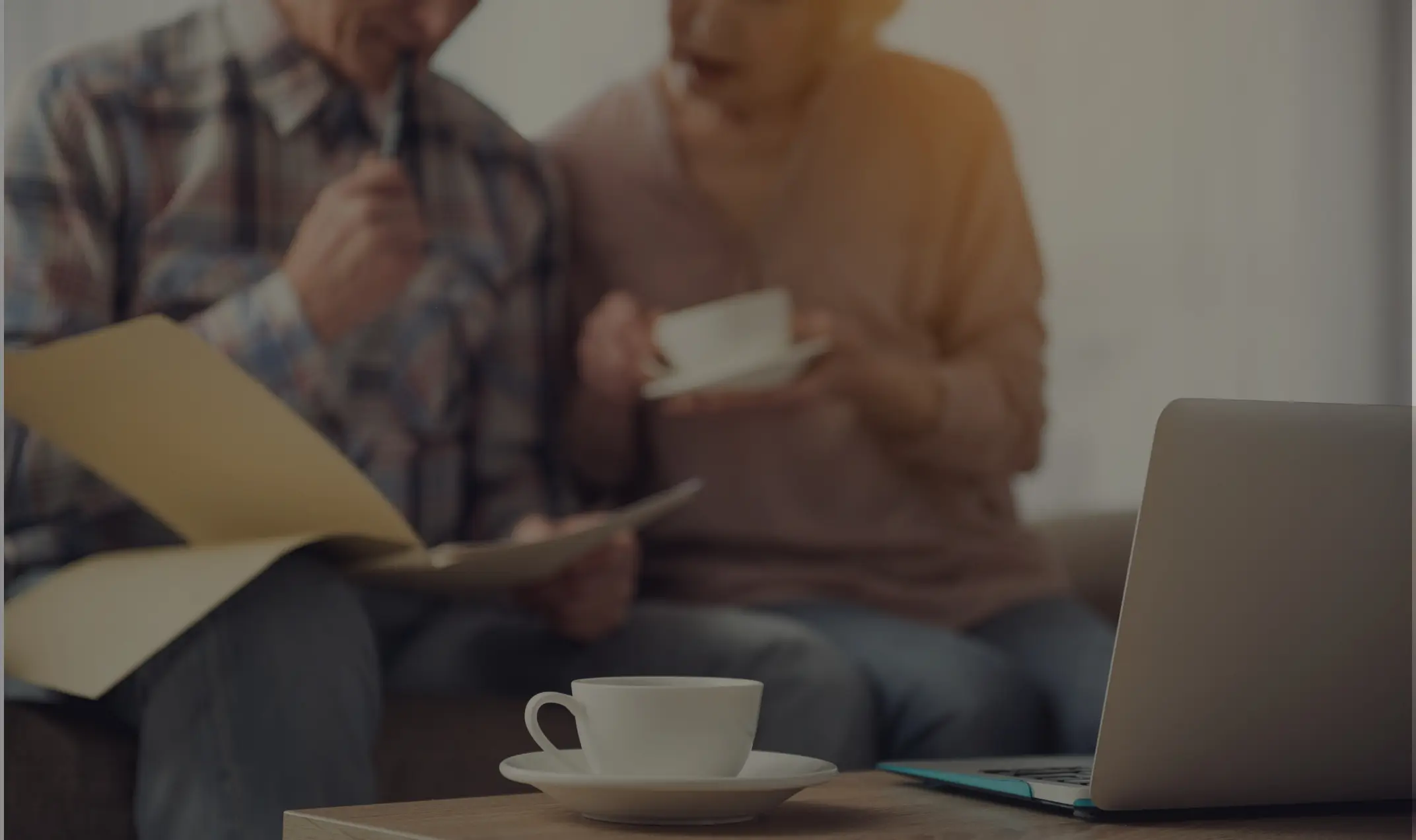 A couple drinking tea looking at documents