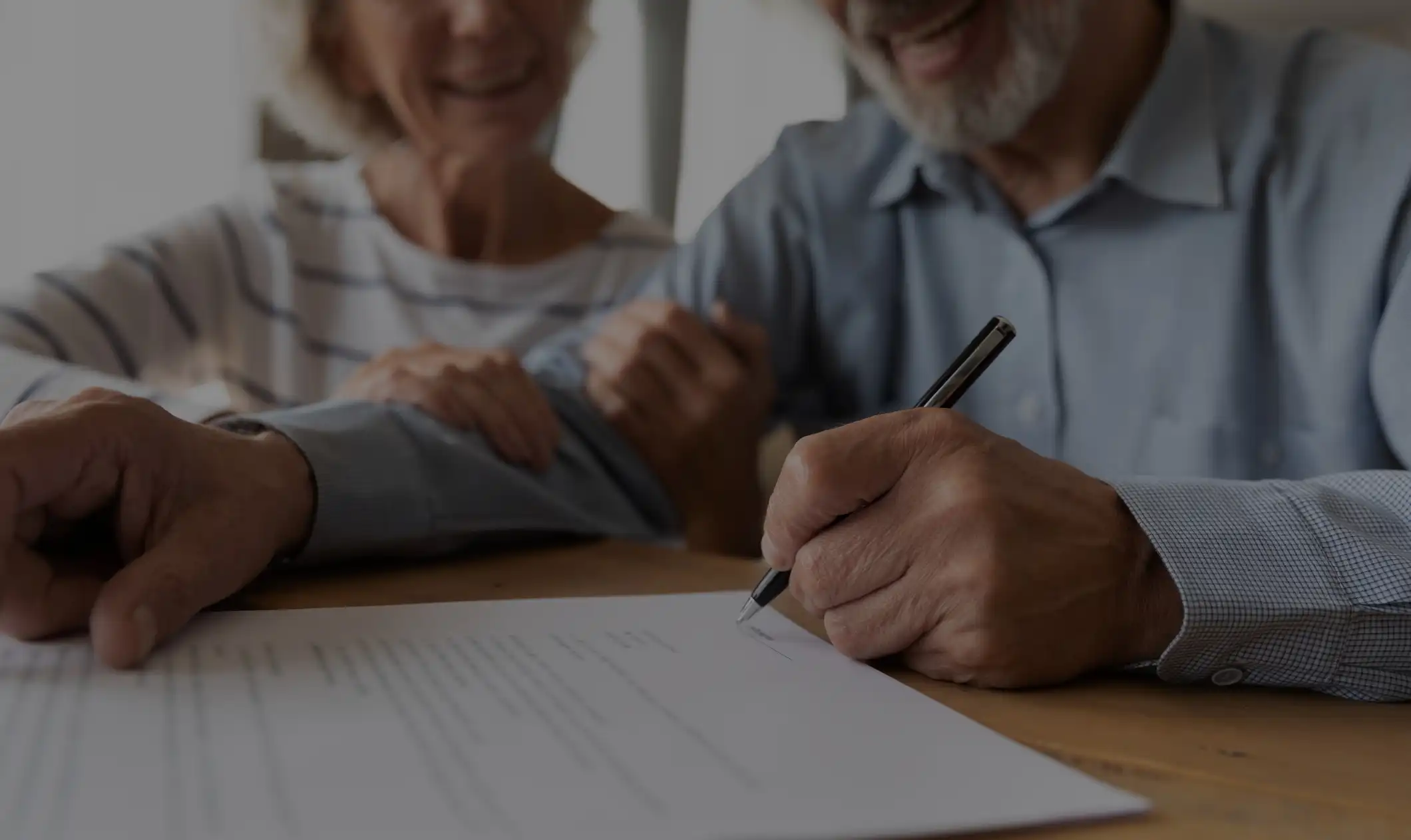 Older man signing document